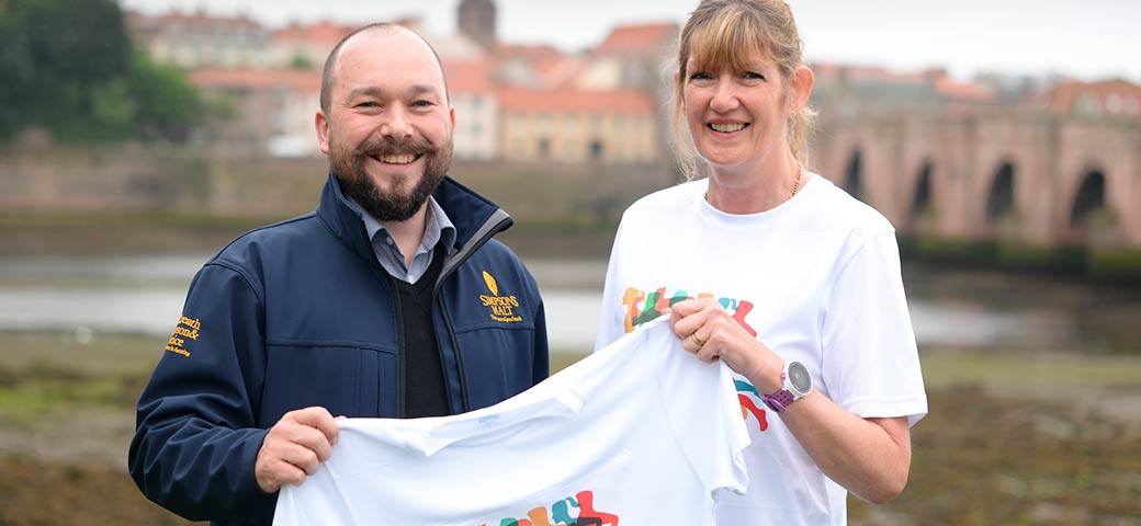 Richard Simpson holding Berwick’s Curfew Run t-shirt with member of Berwick’s Curfew Run