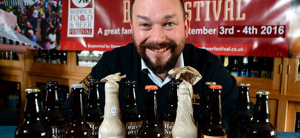 Richard Simpson behind bottles of beer