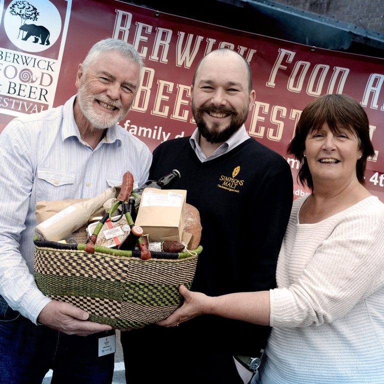 Richard Simpson and others holding food basket at Berwick Food and Beer Festival